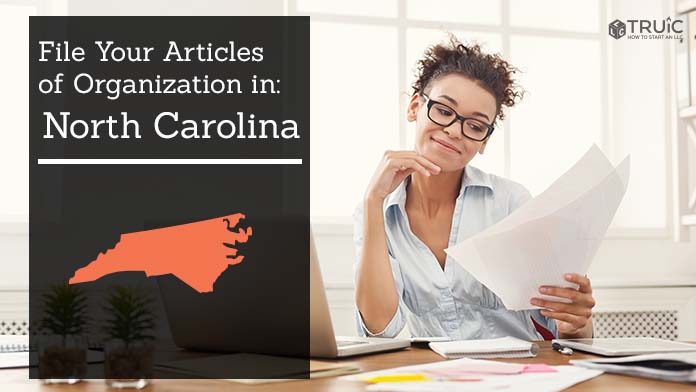 Woman smiling while looking at her articles of organization for North Carolina.